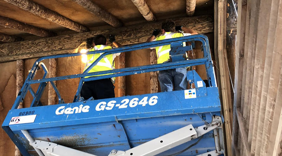 men in blue lift installing bat netting carlsbad ca